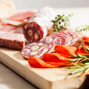 Charcuterie assortment and cheese on wooden board